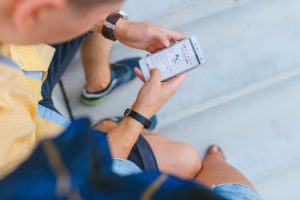 kid sitting with phone in hand